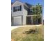 Two-story house with gray siding, white accents, and a landscaped front yard at 1188 To Lani Path, Stone Mountain, GA 30083