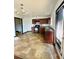 Kitchen with dark brown cabinets, tiled floor, and a chandelier at 1188 To Lani Path, Stone Mountain, GA 30083