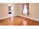 Well-lit bedroom featuring hardwood floors and access to another room at 272 Mount Zion Rd, Hapeville, GA 30354