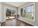 Sunroom with wood-look floors and access to deck through sliding glass doors at 3150 Halifax Dr, Cumming, GA 30041