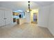 Kitchen and dining area with tile floors, light-colored cabinets, and chandelier at 2884 Norfair Loop, Lithonia, GA 30038