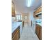 Kitchen with wood cabinets, white appliances, tile floor, and access to backyard at 2884 Norfair Loop, Lithonia, GA 30038