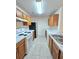 Efficient kitchen featuring wood cabinets, white appliances, and tile floors at 2884 Norfair Loop, Lithonia, GA 30038