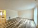 Spacious living room with wood-look vinyl flooring and access to dining area at 2884 Norfair Loop, Lithonia, GA 30038