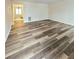 Spacious living room with wood-look vinyl flooring and view to dining area at 2884 Norfair Loop, Lithonia, GA 30038