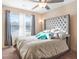 Spacious bedroom featuring a large bed and tufted headboard at 552 Watercourse Way, Lawrenceville, GA 30046