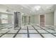 Bright basement recreation room with marble flooring and mirrored walls at 630 Darlington Commons Ne Ct, Atlanta, GA 30305