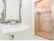 Elegant bathroom with pedestal sink, frameless shower, and ornate mirror at 630 Darlington Commons Ne Ct, Atlanta, GA 30305