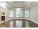 Spacious primary bedroom with hardwood floors and tray ceiling at 630 Darlington Commons Ne Ct, Atlanta, GA 30305