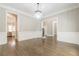 Bright dining room with hardwood floors, chandelier, and kitchen views at 630 Darlington Commons Ne Ct, Atlanta, GA 30305
