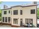 Rear view of the house with light beige siding and dark windows at 630 Darlington Commons Ne Ct, Atlanta, GA 30305