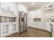 Modern kitchen with white cabinets, stainless steel appliances and wine rack at 630 Darlington Commons Ne Ct, Atlanta, GA 30305