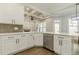 Modern kitchen with white cabinets, stainless steel appliances, and large island at 630 Darlington Commons Ne Ct, Atlanta, GA 30305