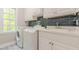 Bright laundry room with white cabinets and subway tile at 630 Darlington Commons Ne Ct, Atlanta, GA 30305