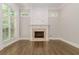 Living room with hardwood floors, fireplace, and large windows at 630 Darlington Commons Ne Ct, Atlanta, GA 30305