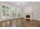 Living room with hardwood floors, fireplace, and large windows at 630 Darlington Commons Ne Ct, Atlanta, GA 30305