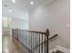 Elegant upper hallway with hardwood floors and iron railing at 630 Darlington Commons Ne Ct, Atlanta, GA 30305