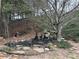Backyard pond with statue and waterfall feature, surrounded by trees and greenery at 665 Roxford Ln, Buford, GA 30518