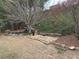 Large backyard with a natural landscape, greenery, and fire pit at 665 Roxford Ln, Buford, GA 30518