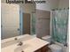 Upstairs bathroom with a vanity and tub with tiled shower walls at 665 Roxford Ln, Buford, GA 30518