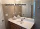 Upstairs bathroom vanity with sink, mirror, updated fixtures, and tiled walls at 665 Roxford Ln, Buford, GA 30518