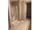 Bathroom featuring shower with glass door, tiled walls, and storage at 665 Roxford Ln, Buford, GA 30518