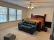 The bedroom has a comfortable seating area with a plush loveseat and a ceiling fan to keep the room cool at 665 Roxford Ln, Buford, GA 30518