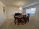 Bright dining room featuring a chandelier and large window that provides ample natural light at 665 Roxford Ln, Buford, GA 30518