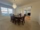 Formal dining room featuring a chandelier, a large window, and an elegant dining table at 665 Roxford Ln, Buford, GA 30518