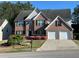 Charming brick two-story home with well-manicured lawn and two-car garage, great curb appeal at 665 Roxford Ln, Buford, GA 30518