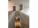 View of the staircase from the second-floor hallway with neutral color palette and lighting at 665 Roxford Ln, Buford, GA 30518