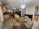 Bright kitchen features wooden cabinets, modern appliances, tiled flooring and dining table with ornate light fixture at 665 Roxford Ln, Buford, GA 30518