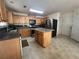 Updated kitchen featuring an island, oak cabinets, stainless steel appliances, and tile flooring at 665 Roxford Ln, Buford, GA 30518