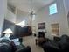 Bright living room with fireplace, two-story windows, ceiling fan, and comfortable seating at 665 Roxford Ln, Buford, GA 30518