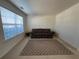 Cozy living room with neutral carpet, a sofa, rug, and large window with natural light at 665 Roxford Ln, Buford, GA 30518