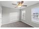 Well-lit bedroom with ceiling fan and two windows at 1029 Chaterly Ct, Riverdale, GA 30296