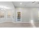 Dining room with hardwood floors, white door, and bay window at 1029 Chaterly Ct, Riverdale, GA 30296