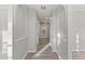 Light gray hallway with hardwood floors and arched niches at 1029 Chaterly Ct, Riverdale, GA 30296