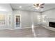 Living room with hardwood floors, fireplace, and French doors leading to patio at 1029 Chaterly Ct, Riverdale, GA 30296