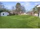 Large grassy backyard with shed and deck at 1207 Eastview Ne Rd, Conyers, GA 30012