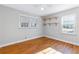 Well-lit bedroom featuring hardwood floors and built-in shelving at 1207 Eastview Ne Rd, Conyers, GA 30012