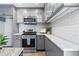 Modern kitchen with gray cabinets, white quartz countertops, and stainless steel appliances at 1207 Eastview Ne Rd, Conyers, GA 30012