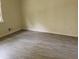 Bedroom featuring wood-look flooring, bright natural light and neutral paint at 345 Lexington Dr, Lawrenceville, GA 30046