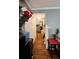 Hallway leading to the kitchen, featuring hardwood floors and a small table and chairs at 345 Lexington Dr, Lawrenceville, GA 30046