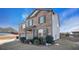 Two-story brick home with gray garage door, landscaping, and partial snow at 8484 Glenview St, Douglasville, GA 30134