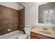 Clean bathroom with brown tile shower/tub combo and wood vanity at 2760 Veltre Sw Ter, Atlanta, GA 30311