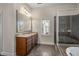 Elegant bathroom with soaking tub, shower, and double vanity at 2760 Veltre Sw Ter, Atlanta, GA 30311