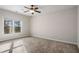 Spacious bedroom with neutral walls and carpet flooring, featuring a ceiling fan and large window at 2760 Veltre Sw Ter, Atlanta, GA 30311