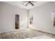 Spacious bedroom with neutral walls and carpet flooring, featuring a ceiling fan and large window at 2760 Veltre Sw Ter, Atlanta, GA 30311