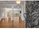 Elegant entry with a wrought iron door, hardwood floors, and views into a spacious living area at 2760 Veltre Sw Ter, Atlanta, GA 30311